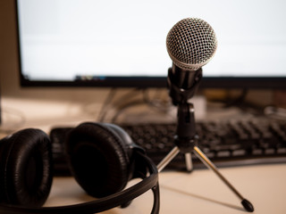 Podcast studio: microphone in stand with headphones and computer