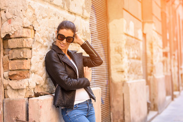 Obraz premium Fashion Portrait of a cheerful young woman in a european urban n