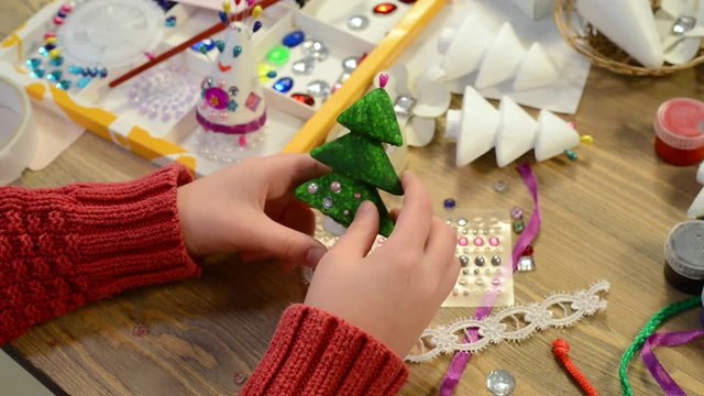 Children making decoration for holidays, crafts and toys, christmas tree and other. Painting watercolors. Top view. Artwork workplace with creative accessories. Flat lay art tools.