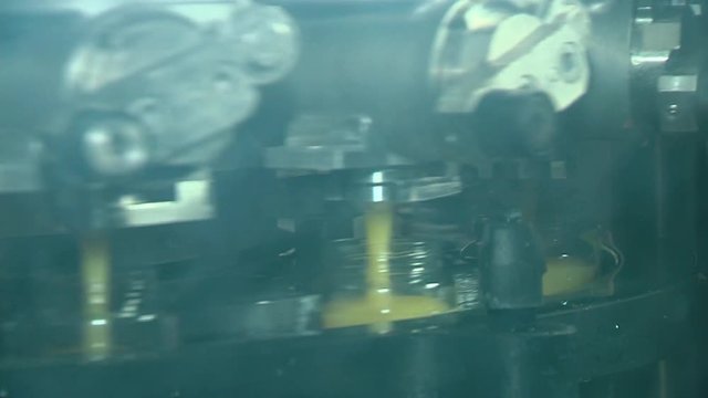 Close-up of  automatic filling of fruit compotes or vegetables in glass jars. Halal bio vegan food.