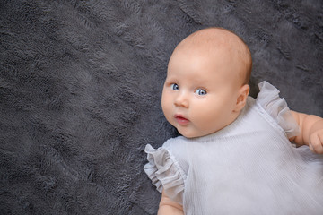 Cute little baby lying on bed