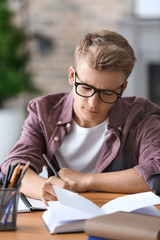 Teenager boy doing homework at home