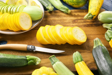 Fresh sliced zucchinis on wooden board