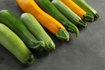 Fresh zucchinis on grey table