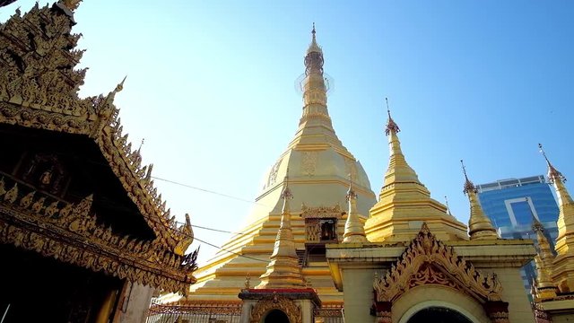 The tiny Karaweik (Brahmin duck) golden boat backs from the stupa of Sule Pagoda after delivering of golden leaf offerings, Yangon, Myanmar.