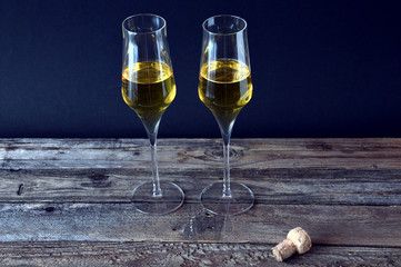 two glasses of spumante wine on wooden plane