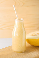 Bottle with delicious melon smoothie on board