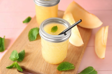 Glass jar with delicious melon smoothie on board