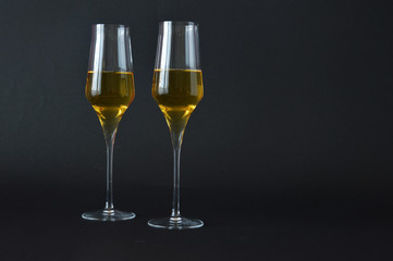 two glasses of spumante wine on dark background