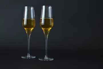 Foto op Aluminium two glasses of spumante wine on dark background © tatiana