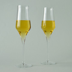 two glasses of spumante wine on white background