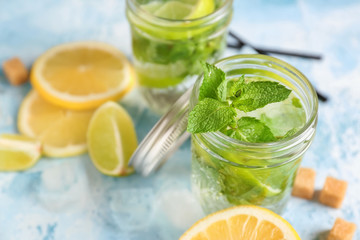 Jar of fresh mojito on color table