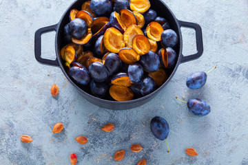 cast iron pot full of plums