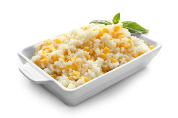 Dish with tasty boiled rice and corn kernels on white background