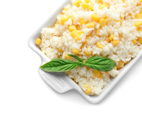 Dish with tasty boiled rice and corn kernels on white background
