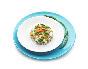 Plate with tasty boiled rice and vegetables on white background
