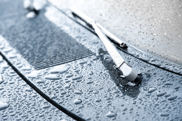 vehicle wiper blade covered in raindrops