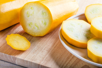 Fresh sliced zucchini on cutting board, on wooden background. Food concept.