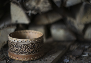 Russian traditional birch bark box at firewoods background