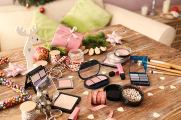 Fototapeta na wymiar Set of cosmetics with decor for Christmas gifts on wooden table