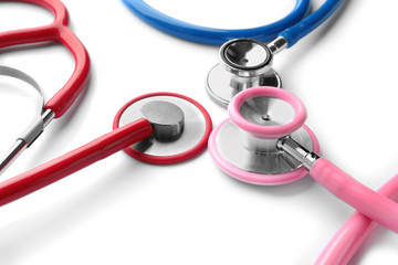 Medical stethoscopes on white background