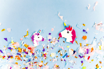 A white unicorn with rainbow horn and confetti top view.