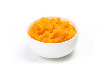A bowl of carrot mud on a white background.