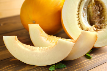 Slices of ripe melon on wooden table