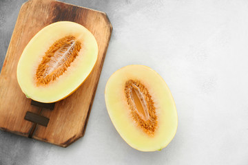 Halves of ripe melon on light background