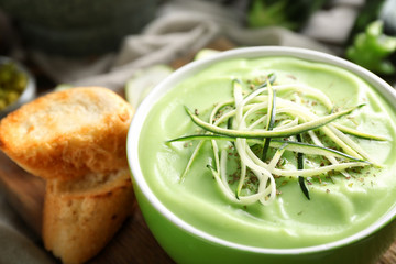 Bowl with delicious zucchini soup, closeup