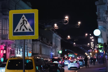 pedestrian sign on a night city street