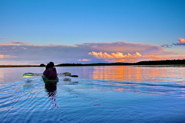 Kayaking on a lake at sunset, Karelia