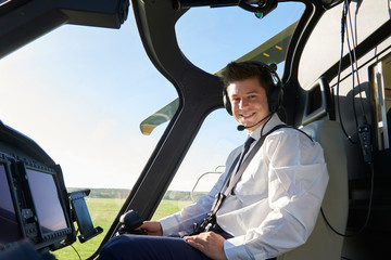 Portrait Of Male Helicopter Pilot In Cockpit Before Flight