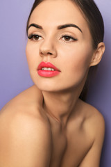 Beautiful young woman with bright lipstick on color background