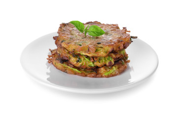 Plate with tasty zucchini pancakes on white background