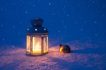 Christmas lantern and toy in the snow