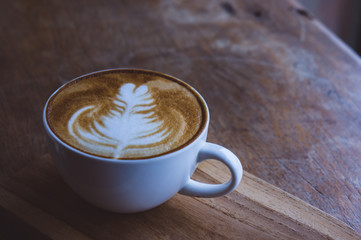 coffee hot drink cappucino latte art on wood vintage table , coffee time on wood background cafe