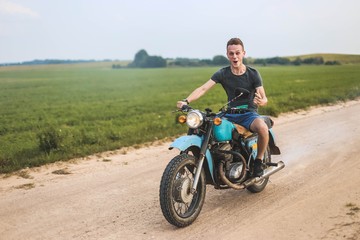 Plakat man is traveling on a classic retro motorcycle