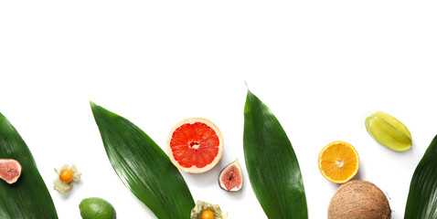 Summer composition with fresh tropical leaves and fruits on white background