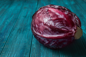 Ripe red cabbage on color wooden table