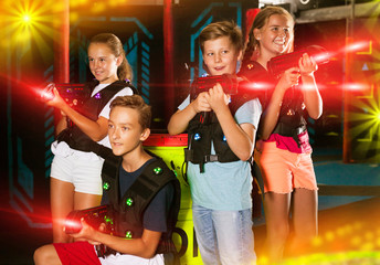 Girls and boys posing with laser pistols