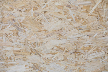 Close-up plywood sheet made of big cuttings texture background