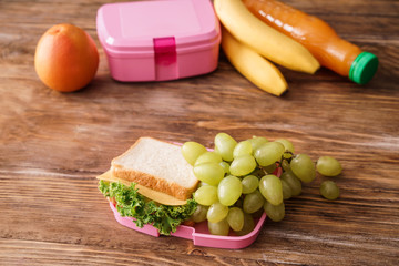 Appetizing food for schoolchild on wooden table