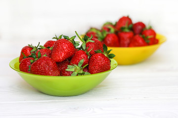 Bowls with tasty strawberries
