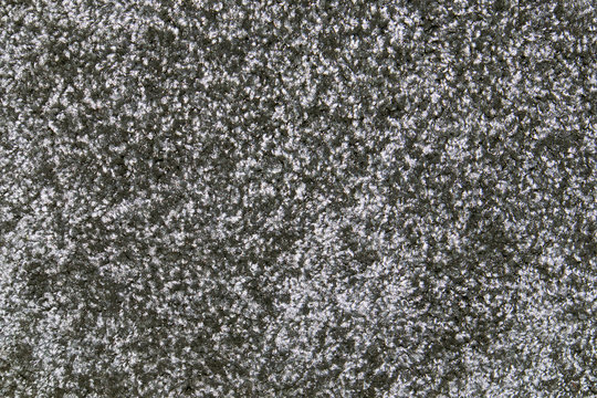 Grey synthetic short-napped floor carpet covering, may be used as background or texture