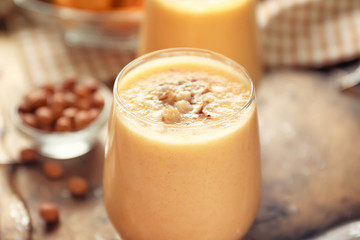 Glass with tasty melon smoothie on tray, closeup