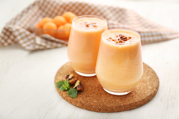Glasses with tasty fresh melon smoothie on white table