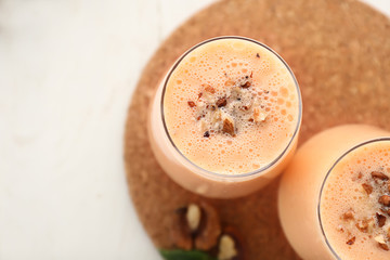 Glasses with tasty fresh melon smoothie on white table, closeup