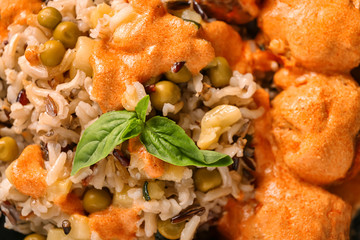 Delicious boiled rice with meatballs and vegetables, closeup
