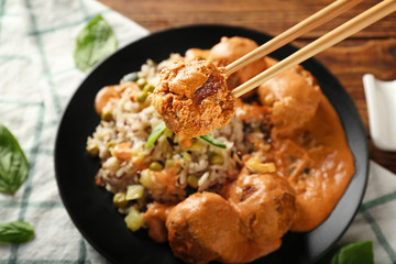 Eating of meatball with boiled rice, closeup